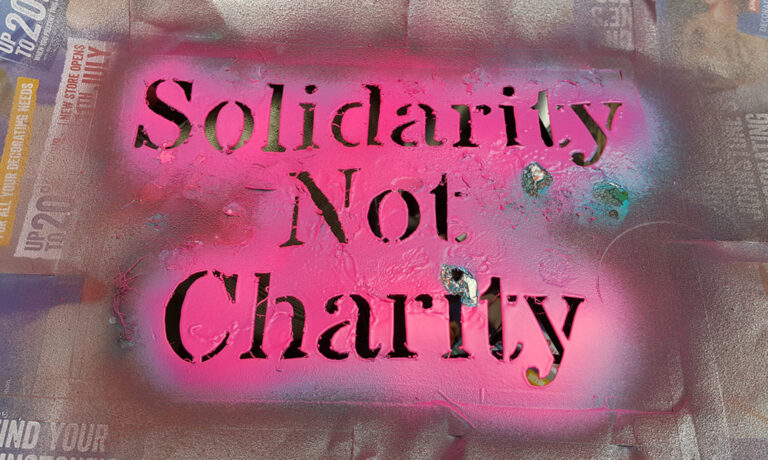 cropped solidarity not charity stencil2 768x460