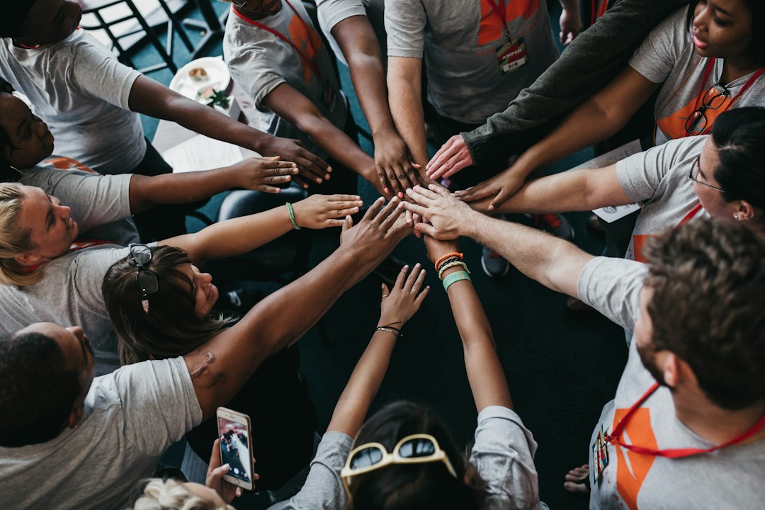 Community volunteers joining hands in solidarity