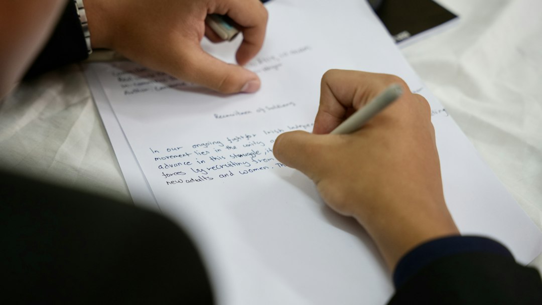 Person writing, photograph by Ojus Jaiswal